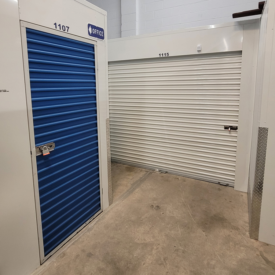 Clean interior drive-aisle with roll-up storage unit doors at StorageBlue Clifton